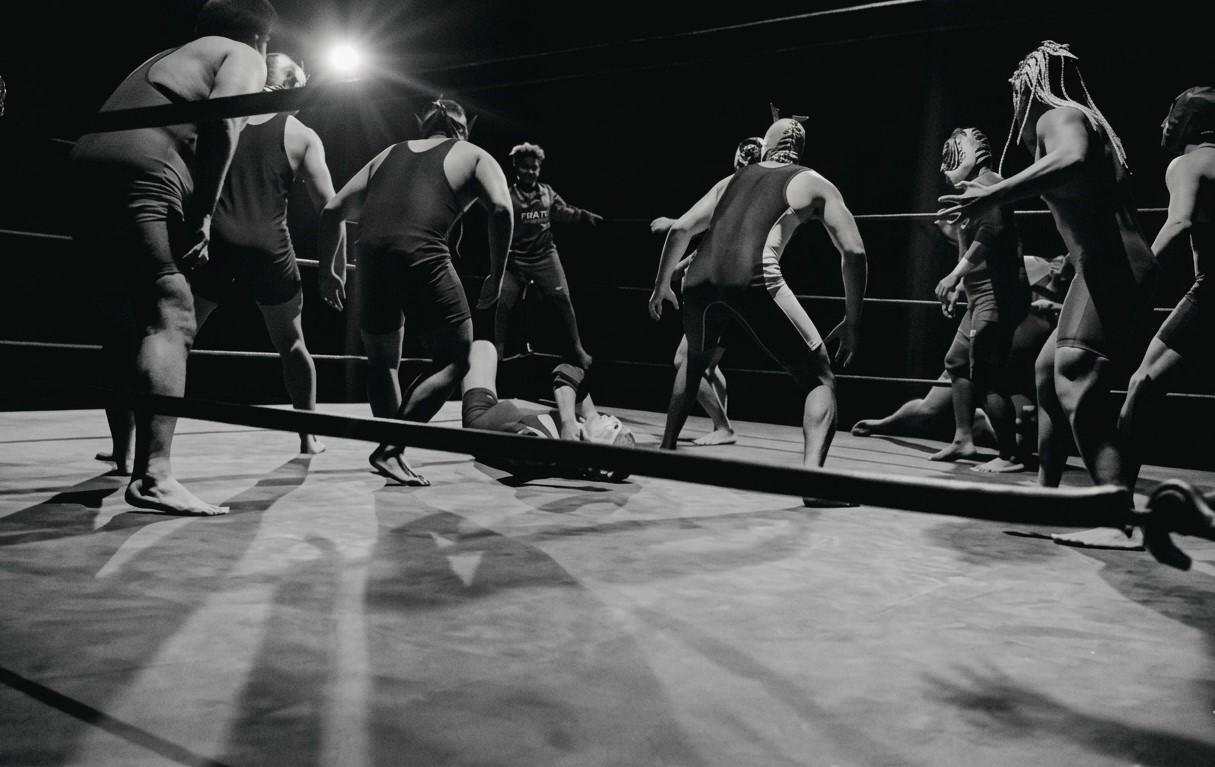 Wrestlers performing in the ring on stage